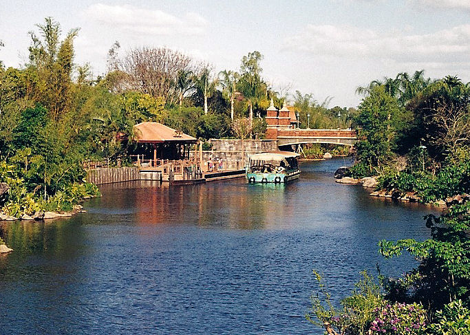 A river in Disney's Animal Kingdom with a boat on it in Walt Disney World. A river in Disney's Animal Kingdom with a boat on it in Walt Disney World.
