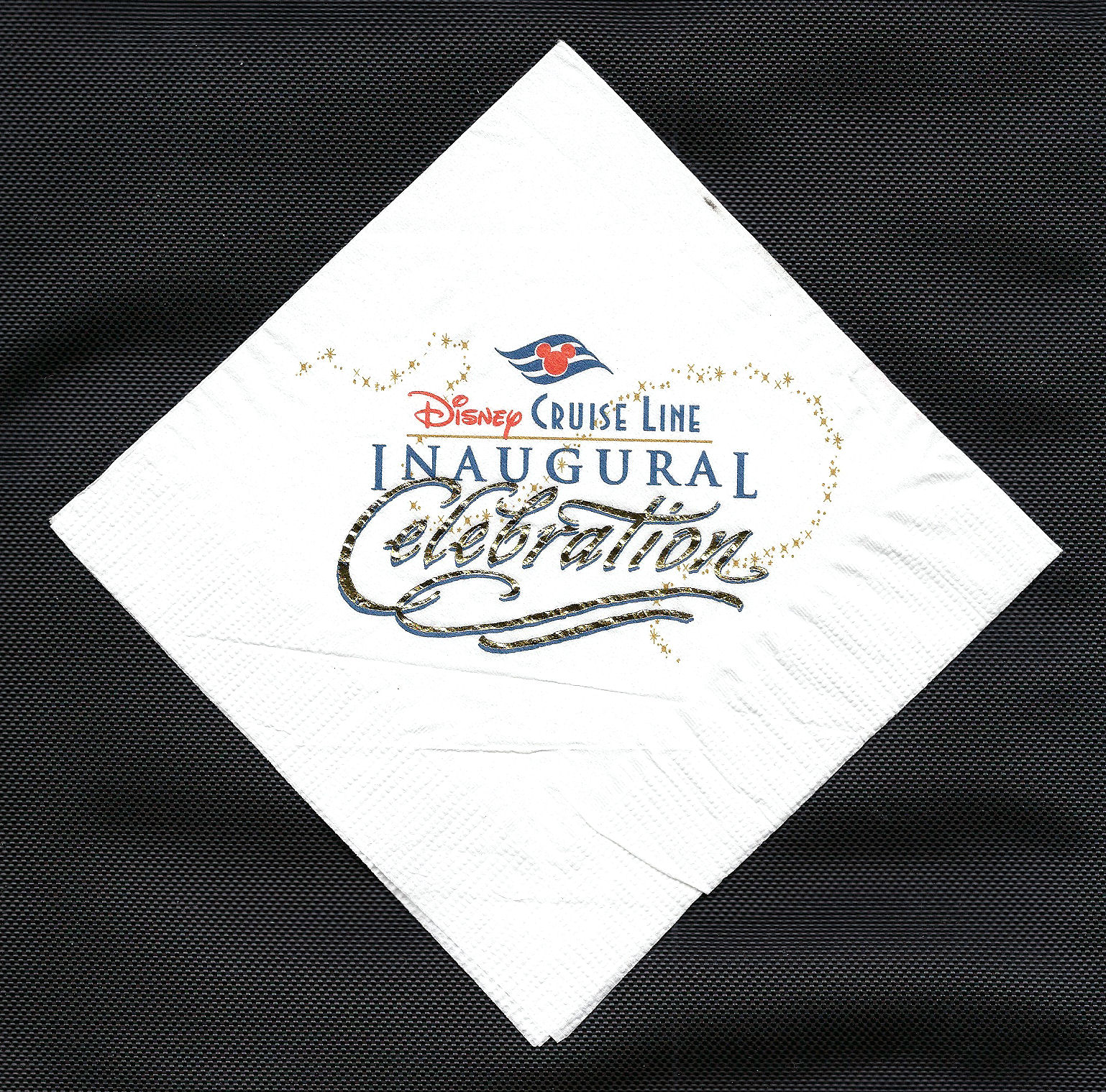 A napkin honoring the Disney Cruise Line's inaugural celebration. A napkin honoring the Disney Cruise Line's inaugural celebration.