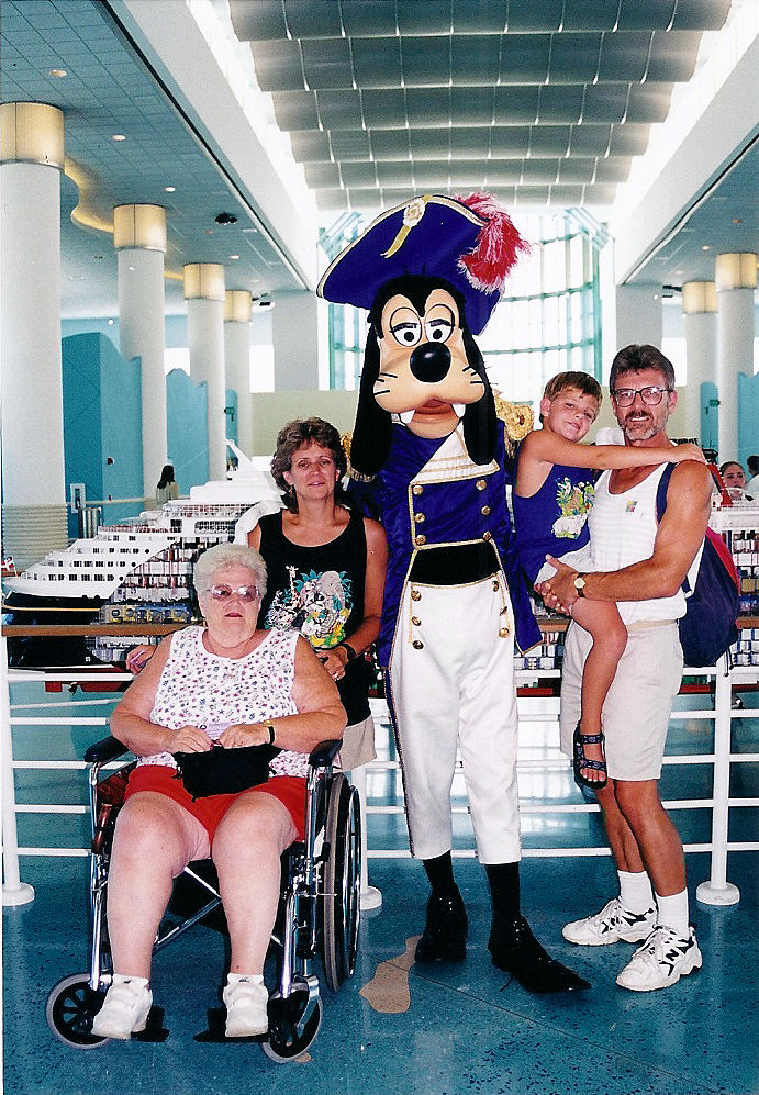 From left to right: my grandmother, my mother, Captain Goofy, me, and my dad, right before we got on the ship for the Disney Cruise Line.