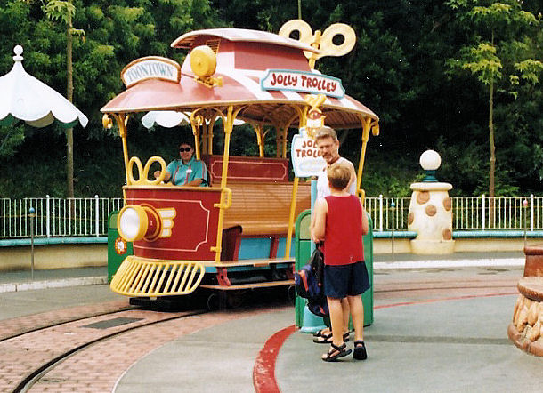 My dad and I by a Jolly Trolly in Mickey's Toontown at Disneyland.