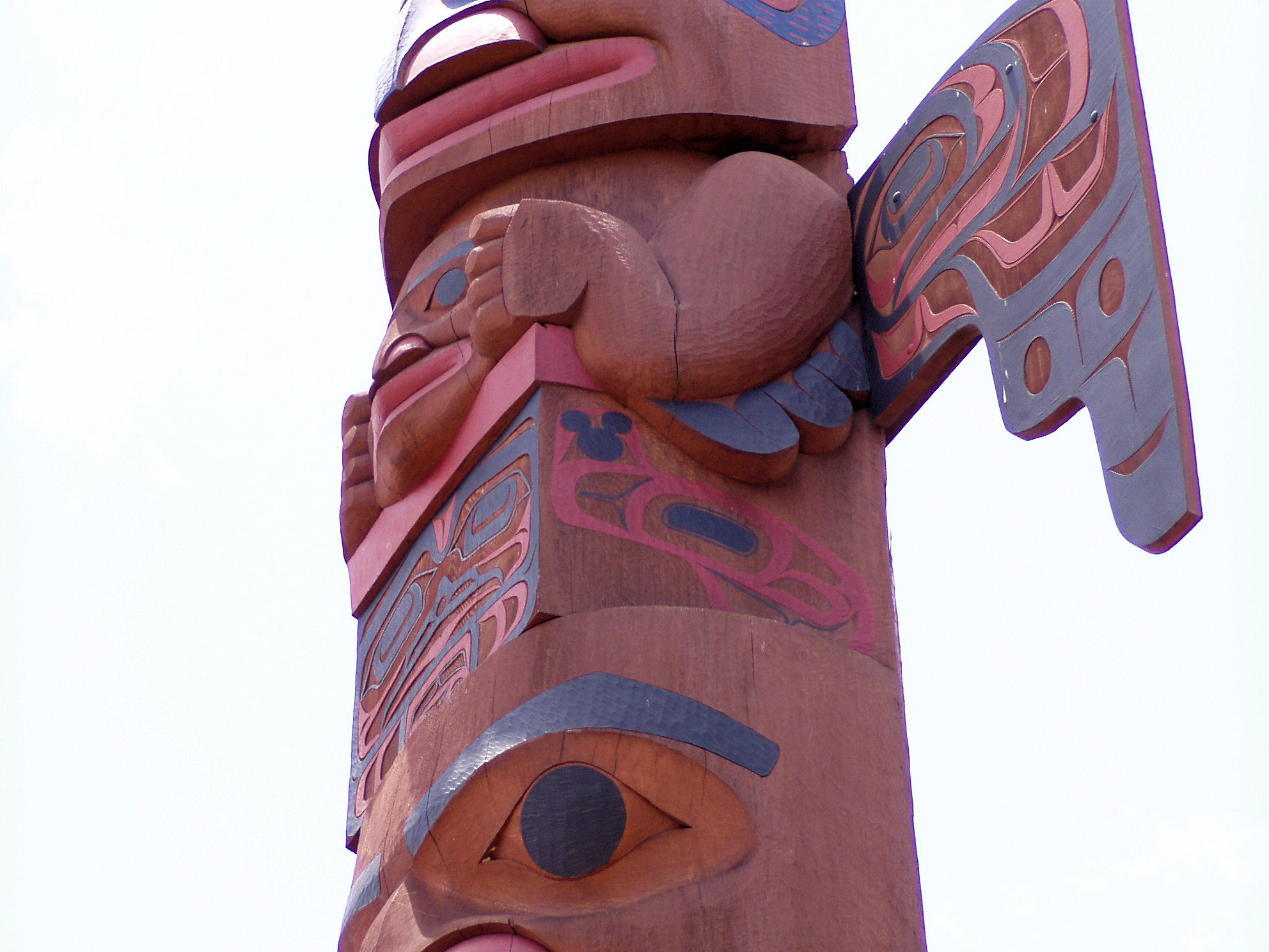 A Hidden Mickey on a totem pole in the Canada Pavilion at EPCOT.