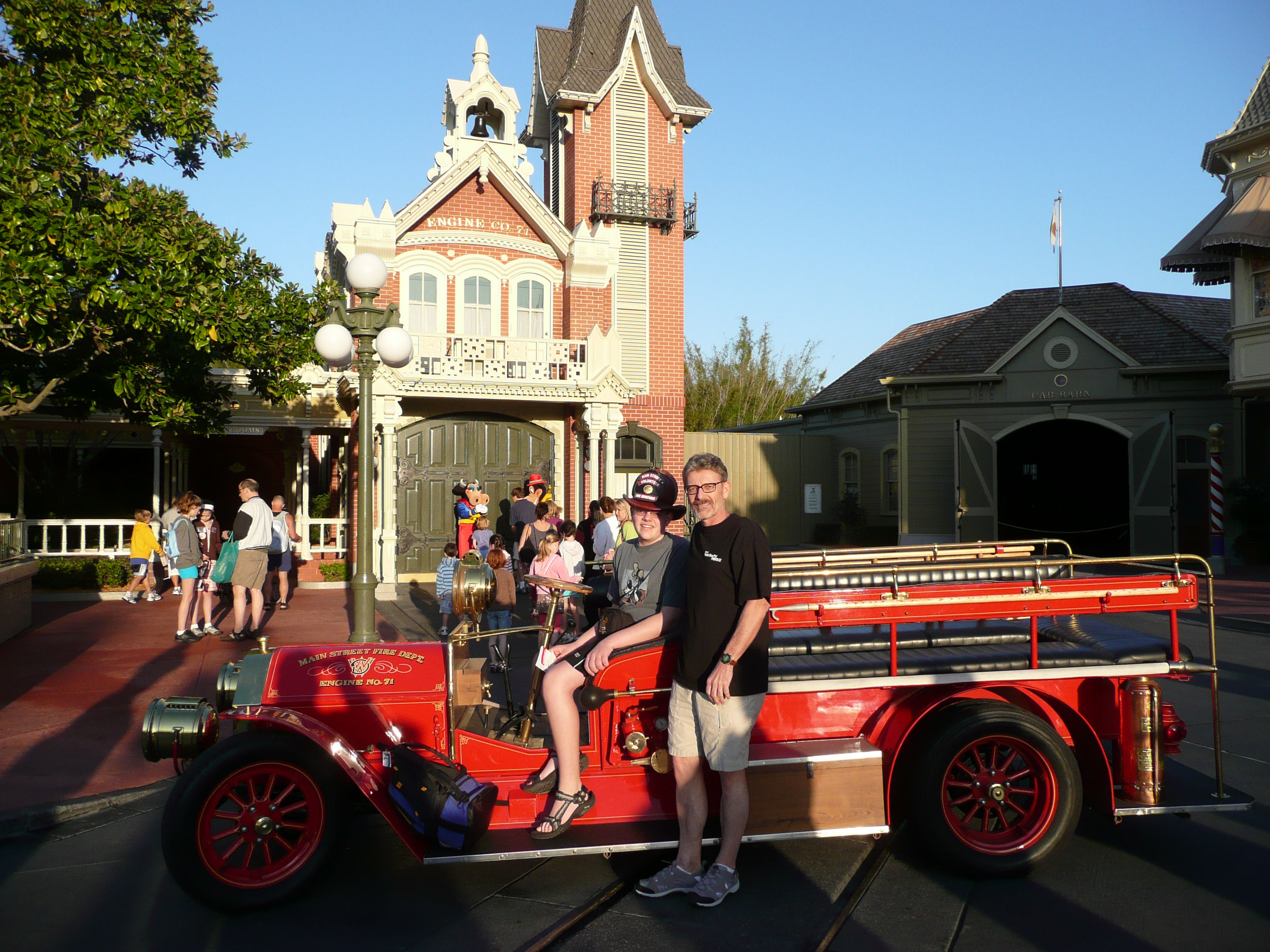 Main Street, USA at Disney World; Dad and I with a fire truck with me wearing a fireman's helmet.