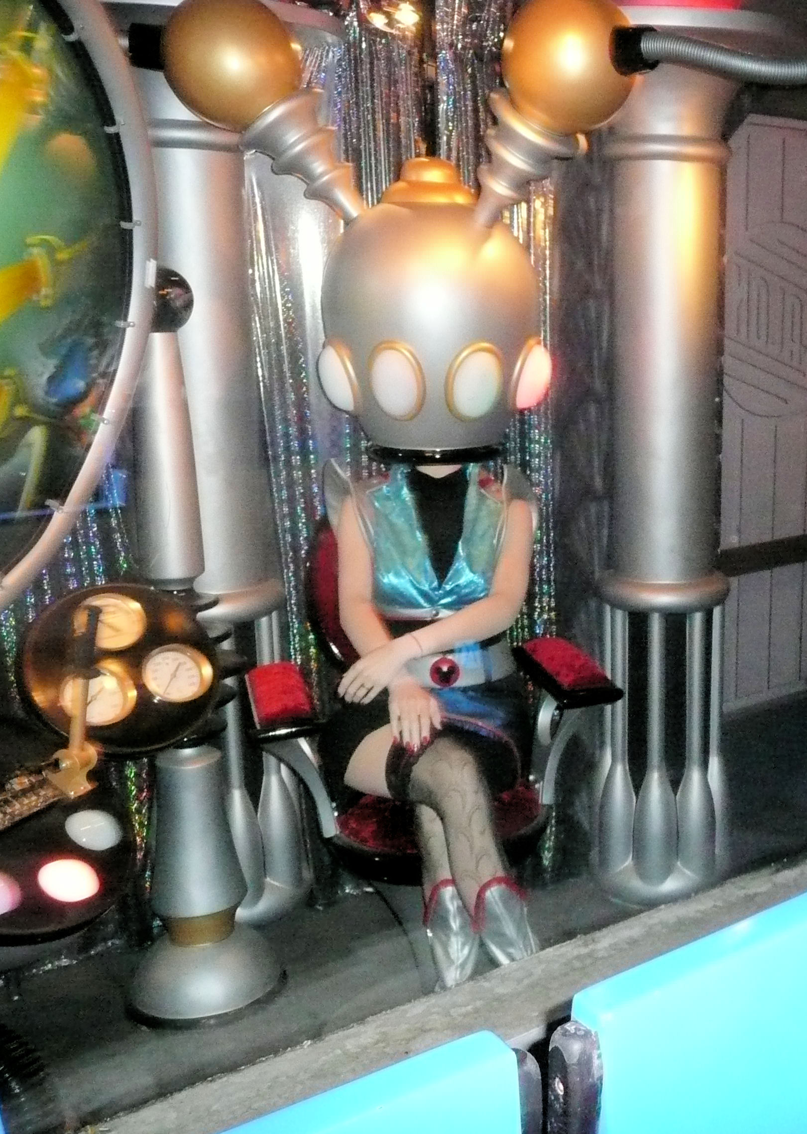 A Hidden Mickey on the woman's belt buckle; seen on the Tomorrowland Transit Authority ride, Magic Kingdom, Disney World.